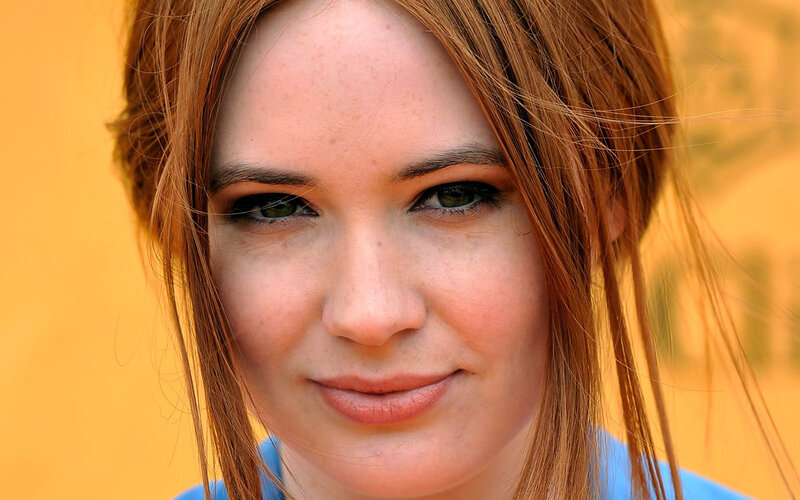 woman with red hair smiling