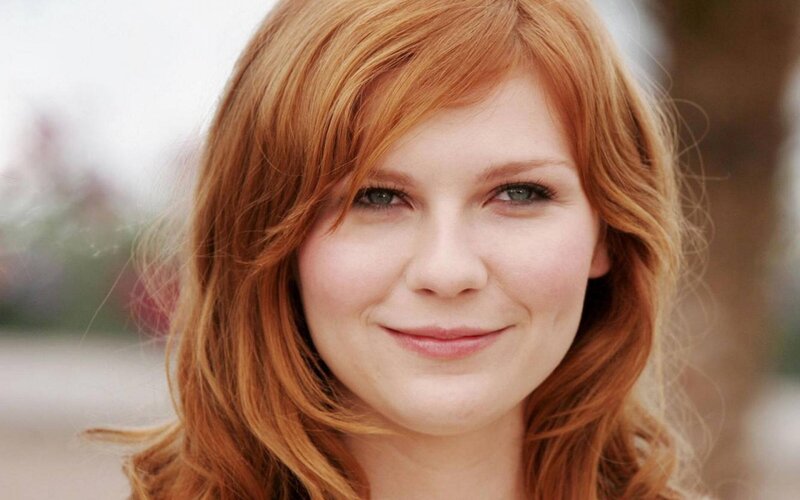 woman with red hair smiling