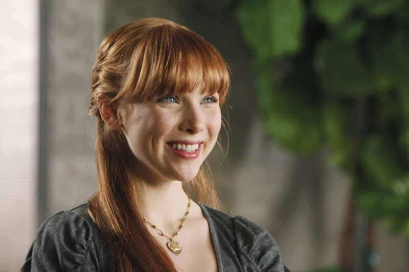 woman with red hair smiling