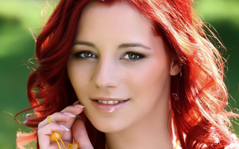 woman with red hair smiling