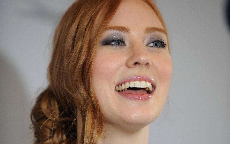 woman with red hair smiling