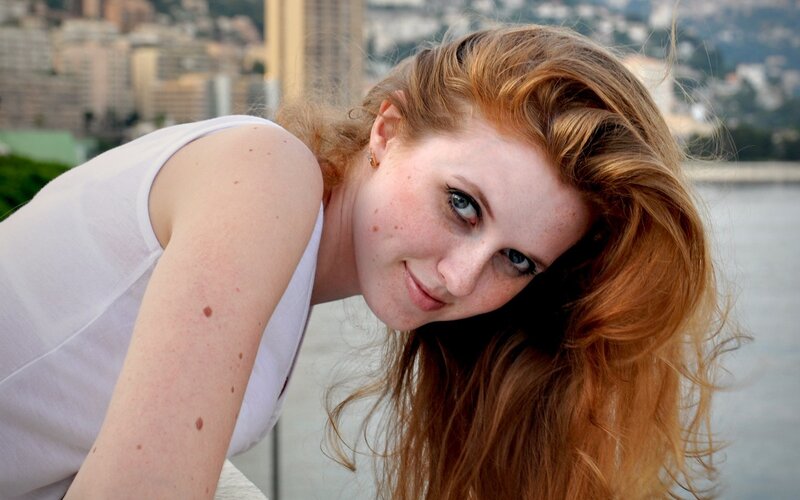 woman with red hair smiling