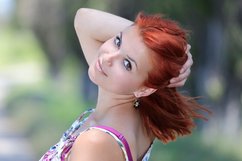woman with red hair smiling