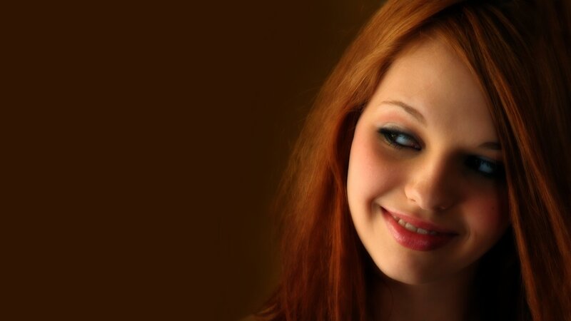 woman with red hair smiling