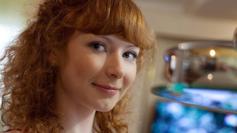 woman with red hair smiling