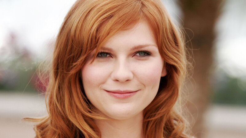 woman with red hair smiling
