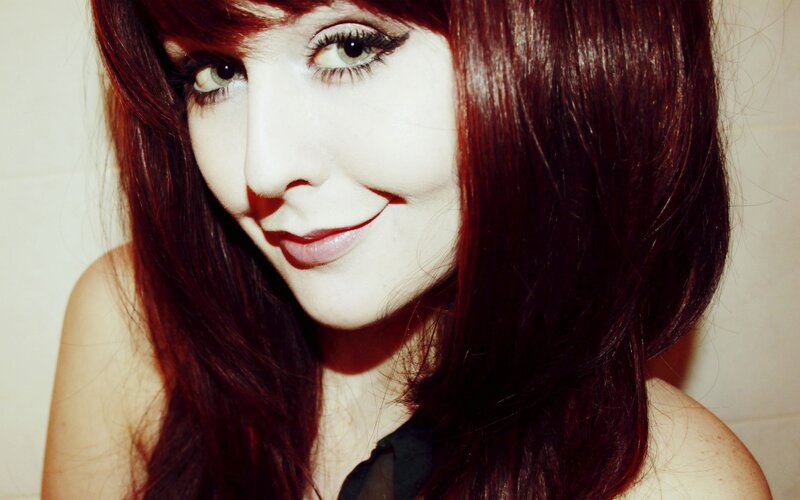 woman with red hair smiling