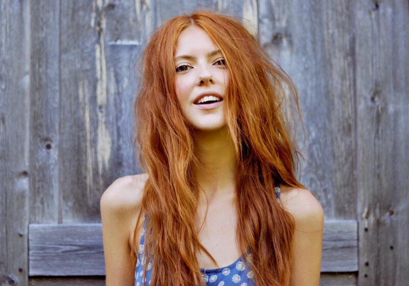 woman with red hair smiling