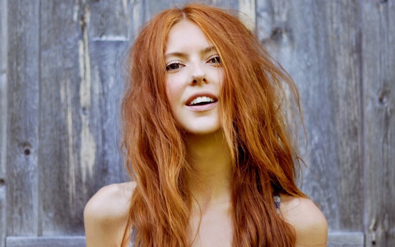 woman with red hair smiling