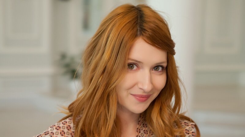 woman with red hair smiling