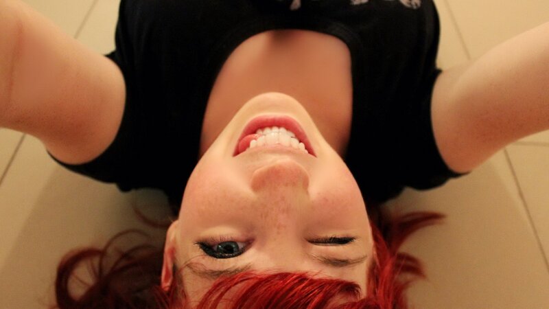 woman with red hair smiling