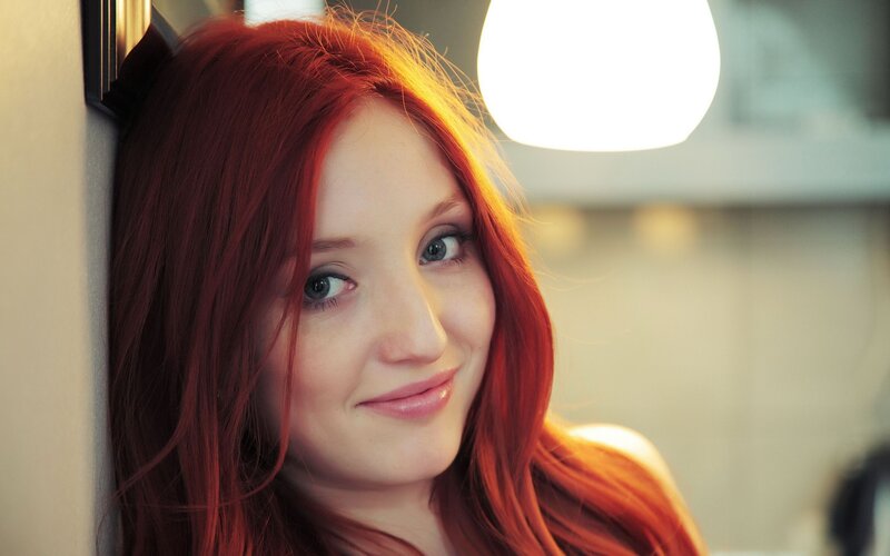 woman with red hair smiling