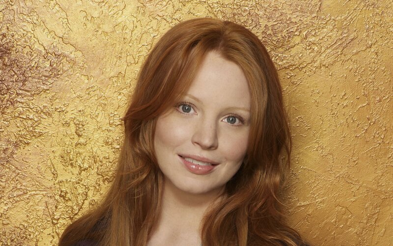 woman with red hair smiling