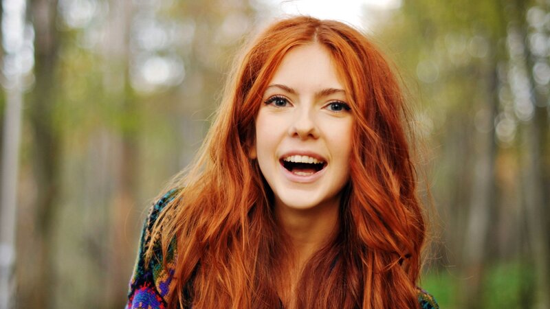 woman with red hair smiling