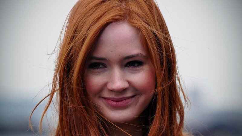 woman with red hair smiling