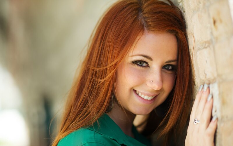 woman with red hair smiling