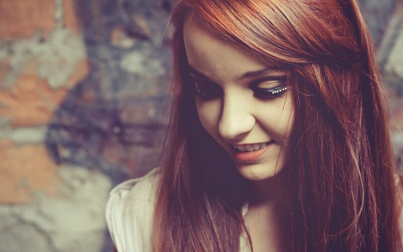 woman with red hair smiling