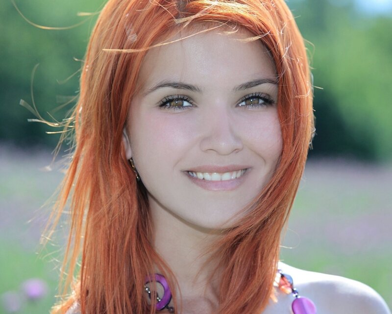 woman with red hair smiling