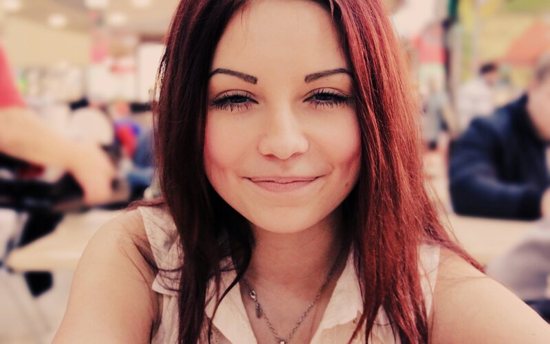 woman with red hair smiling