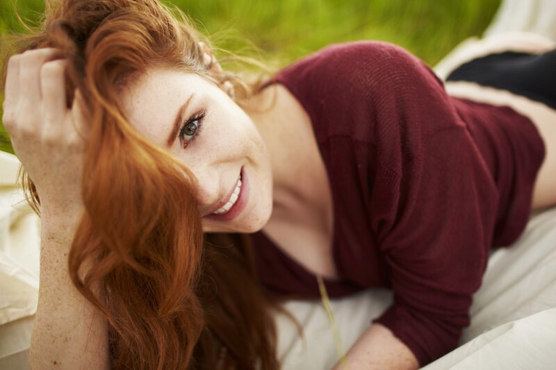 woman with red hair smiling