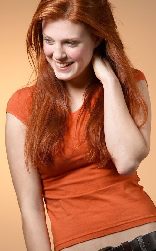 woman with red hair smiling