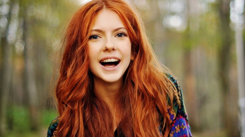 woman with red hair smiling