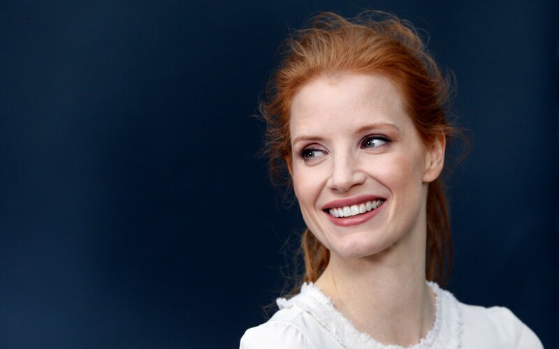 woman with red hair smiling