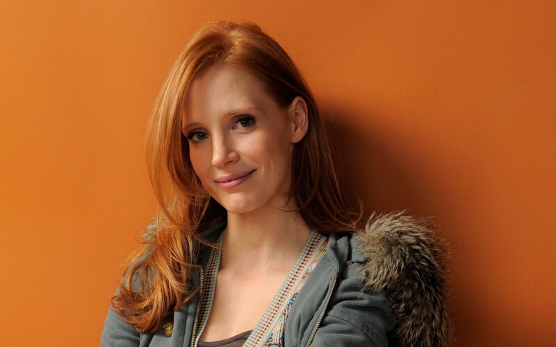 woman with red hair smiling