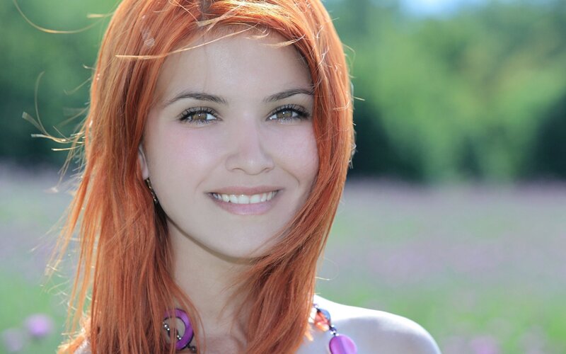 woman with red hair smiling