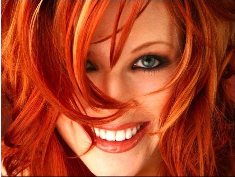 woman with red hair smiling