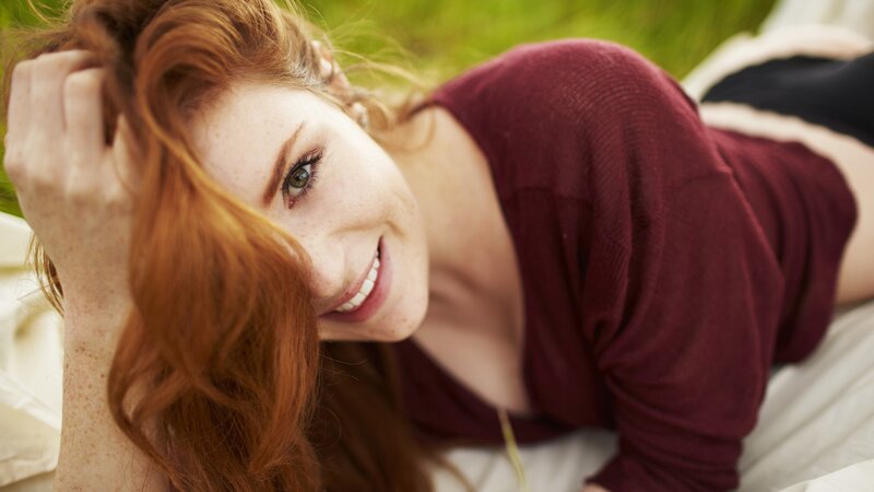 woman with red hair smiling
