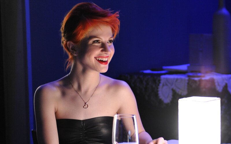 woman with red hair smiling