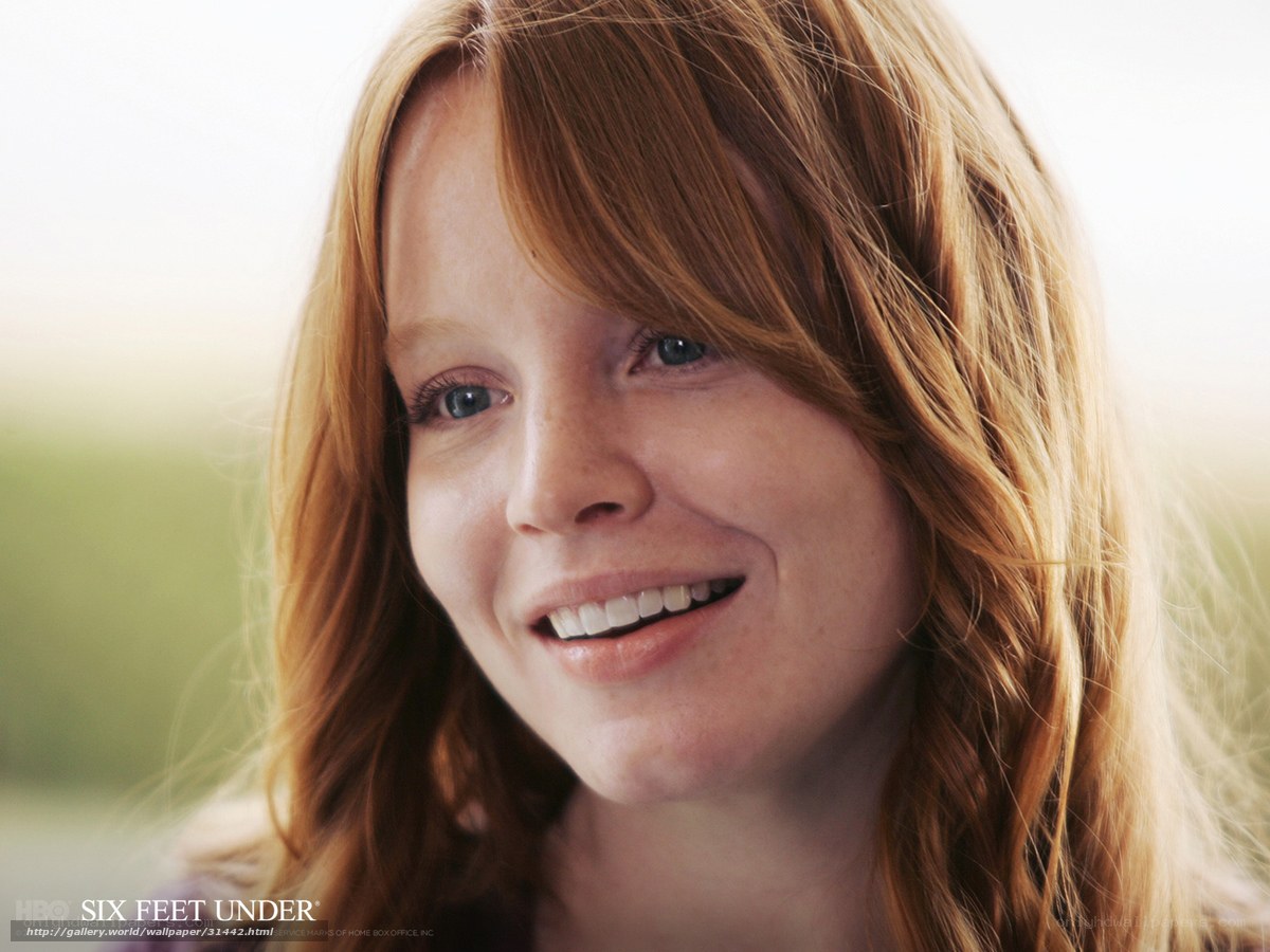 woman with red hair smiling