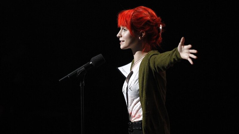 woman with red hair speaking