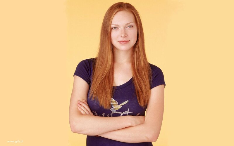 woman with red hair standing