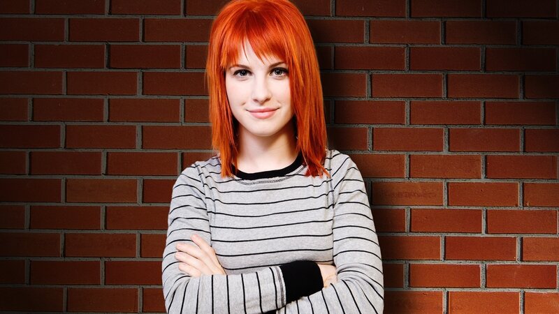 woman with red hair standing