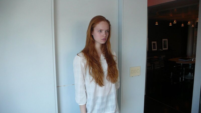woman with red hair standing