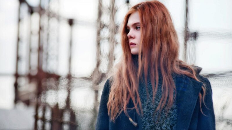 woman with red hair standing