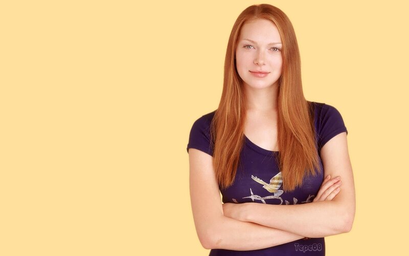 woman with red hair standing