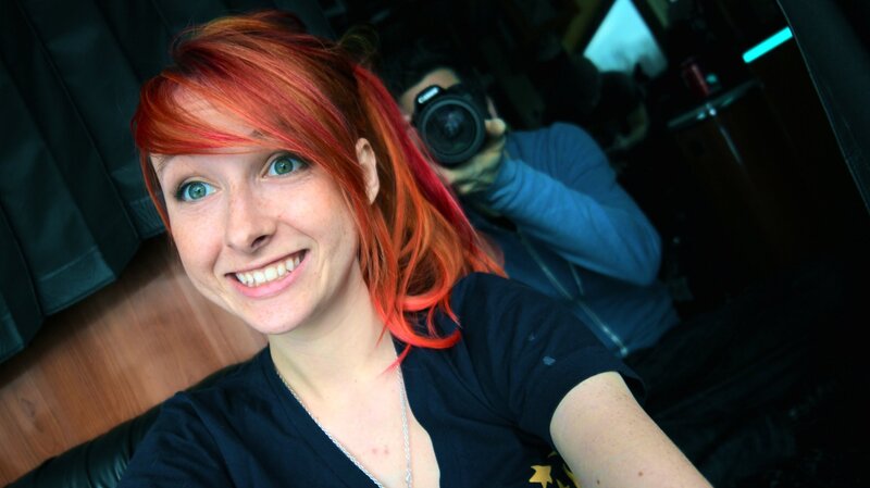 woman with red hair taking selfie