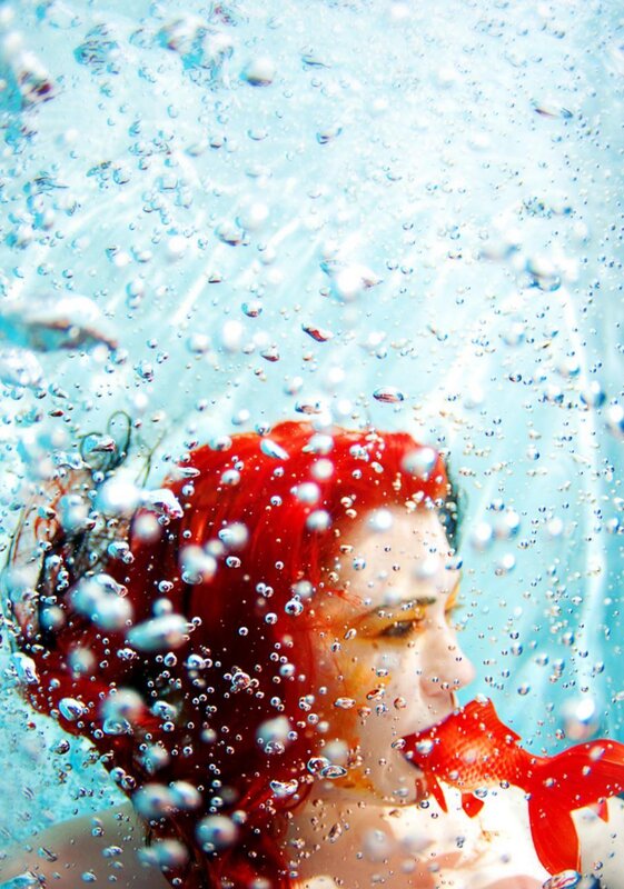 woman with red hair underwater