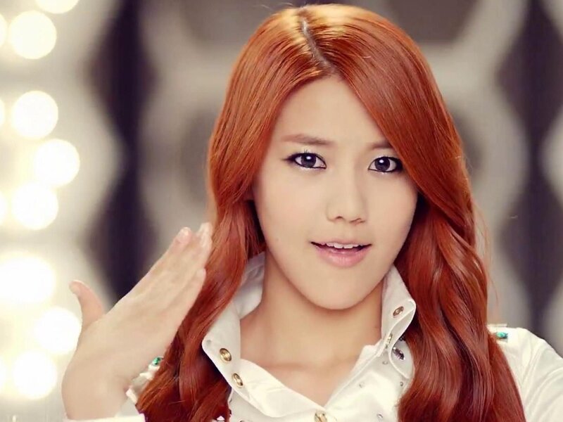 woman with red hair waving