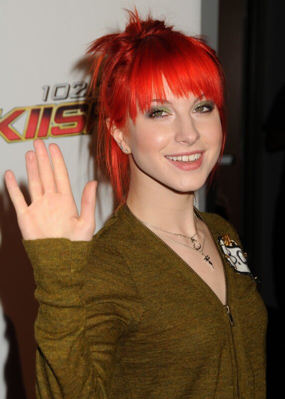 woman with red hair waving
