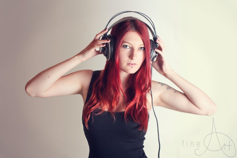 woman with red hair wearing headphones