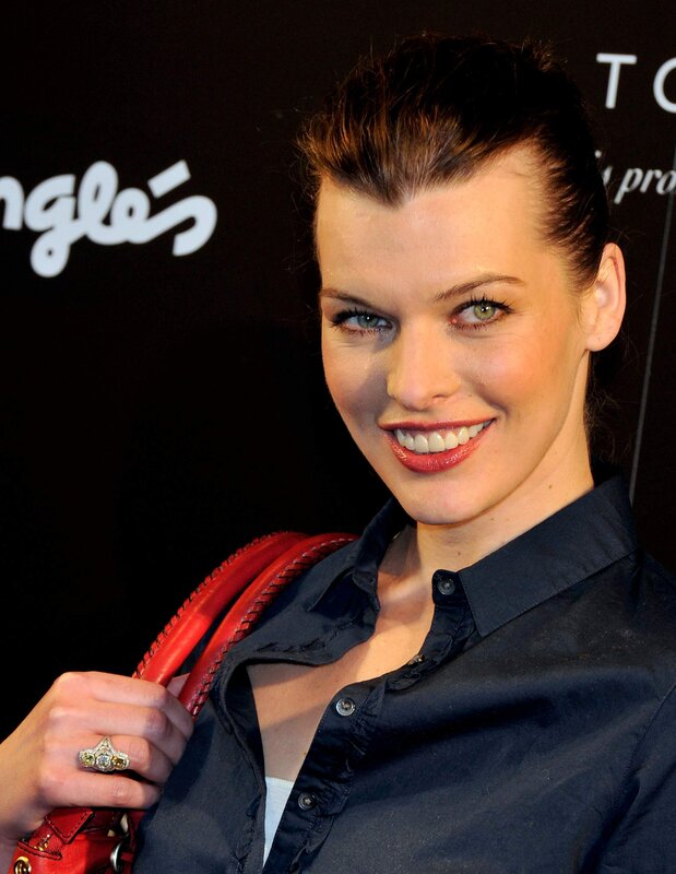 woman with red handbag smiling