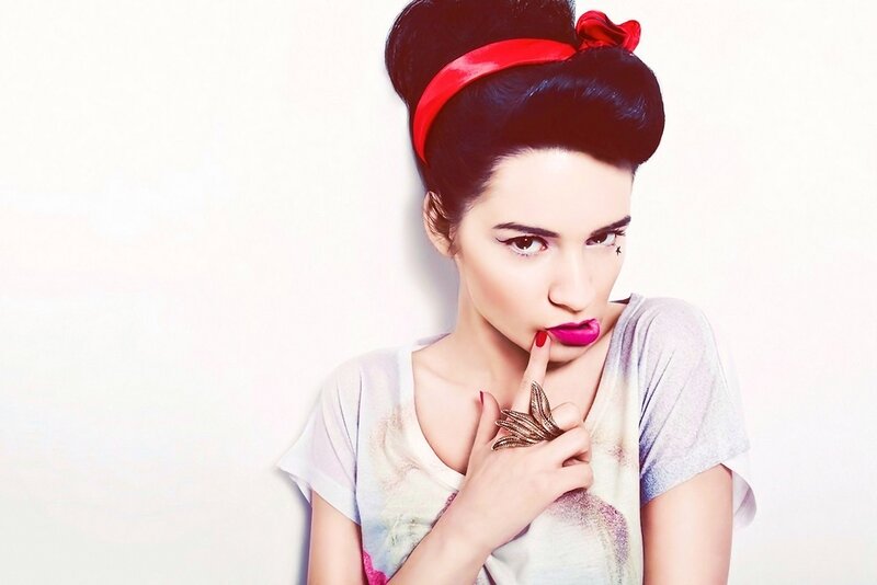 woman with red headband and bold makeup