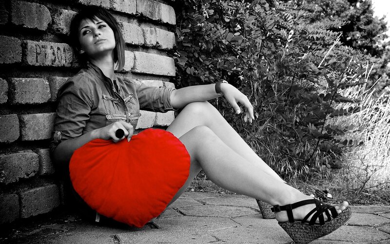 woman with red heart pillow