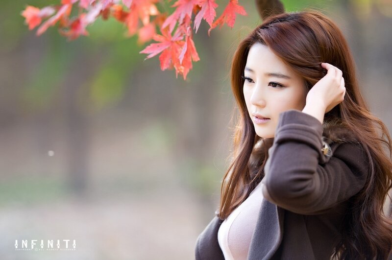 woman with red leaves in autumn