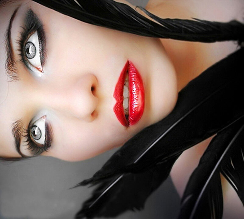 woman with red lips and black feathers