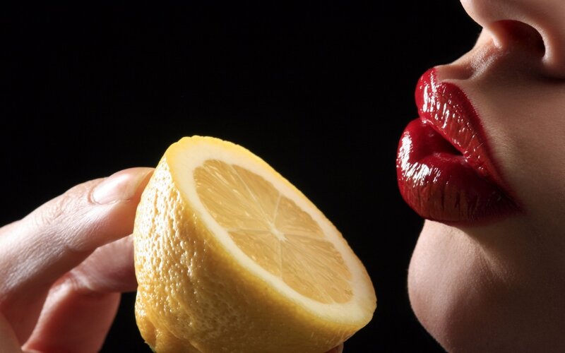 woman with red lips and lemon